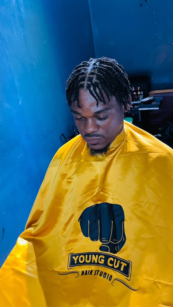 Short braided hairstyle with a yellow YOUNGCUT cape
